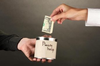 offering-help-to-a-homeless-man-on-black-backdrop-photo